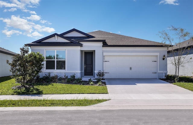 ranch-style house featuring a front yard and a garage