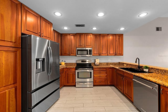 2618 Crestfield Dr, Valrico, FL 33596 - kitchen with appliances with stainless steel finishes, a sink, recessed lighting, stone countertops, and brown cabinets