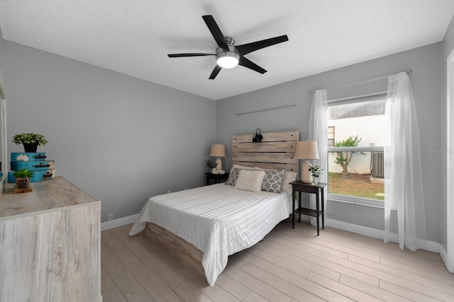 2618 Crestfield Dr, Valrico, FL 33596 - bedroom featuring baseboards, wood finished floors, a textured ceiling, and a ceiling fan