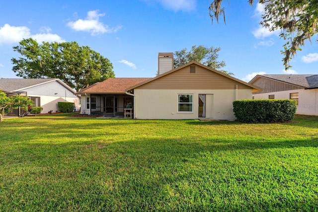 2618 Crestfield Dr, Valrico, FL 33596 - back of house featuring a sunroom, a yard, and a chimney