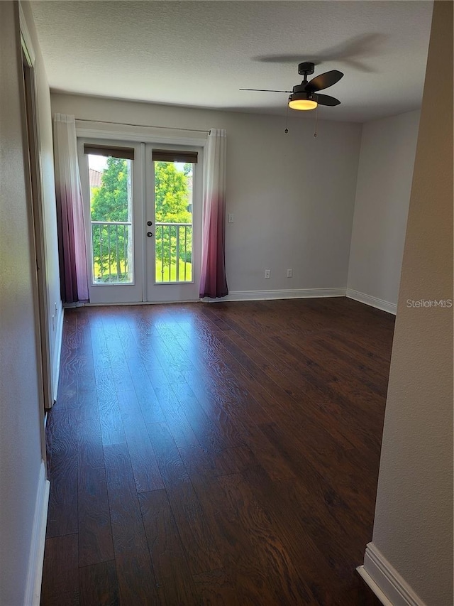 empty room with dark hardwood / wood-style floors and ceiling fan