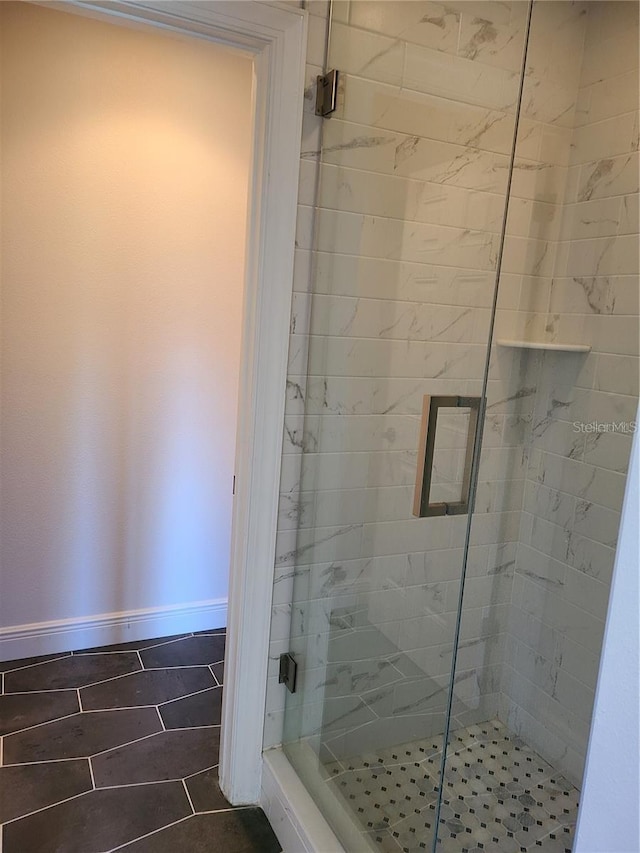 bathroom featuring a shower with door