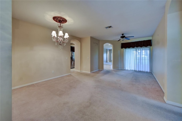 unfurnished room featuring an inviting chandelier and light carpet