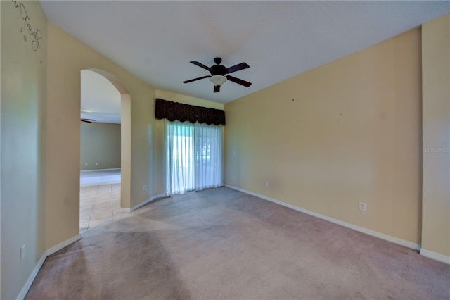 carpeted spare room with ceiling fan