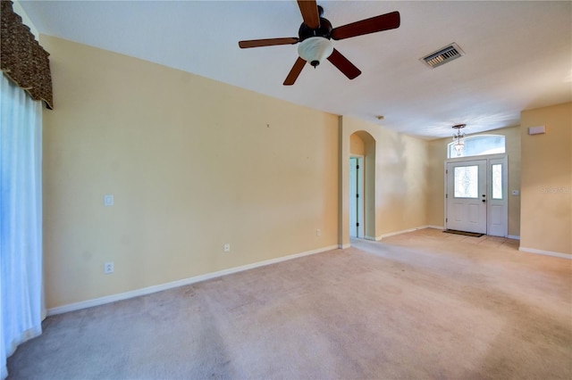 carpeted empty room featuring ceiling fan