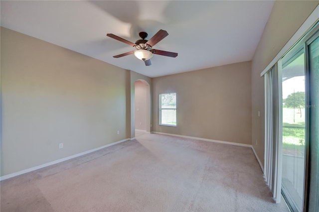 unfurnished room with ceiling fan and light colored carpet