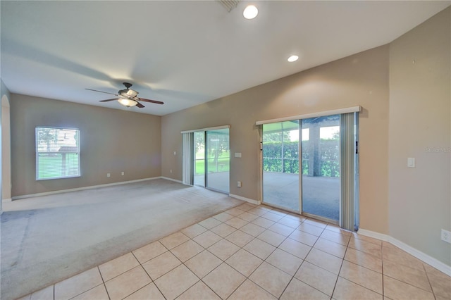 spare room featuring plenty of natural light, ceiling fan, and light tile patterned flooring