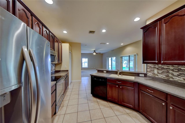 kitchen with sink, backsplash, light tile patterned floors, ceiling fan, and stainless steel appliances