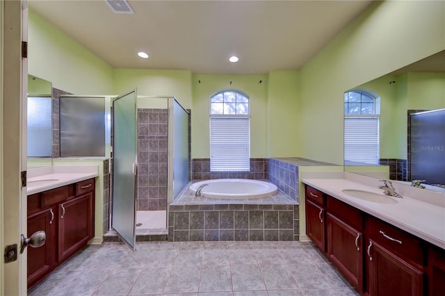 bathroom featuring tile patterned floors, vanity, and shower with separate bathtub