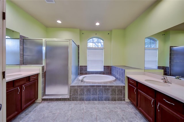 bathroom featuring vanity, tile patterned floors, and plus walk in shower