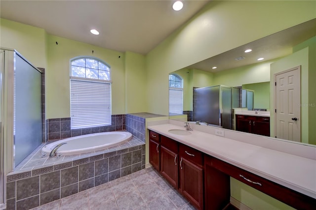 bathroom featuring vanity, tile patterned flooring, and shower with separate bathtub