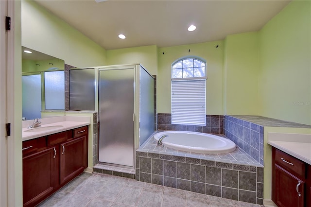 bathroom featuring vanity, tile patterned flooring, and shower with separate bathtub