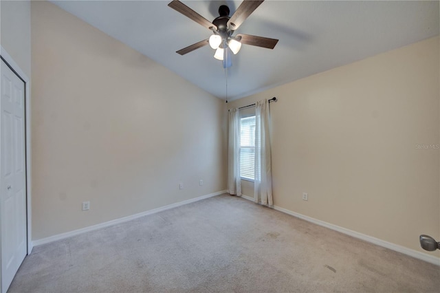 carpeted empty room featuring lofted ceiling and ceiling fan