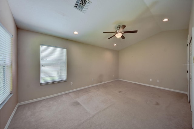 unfurnished room with ceiling fan, light colored carpet, and vaulted ceiling