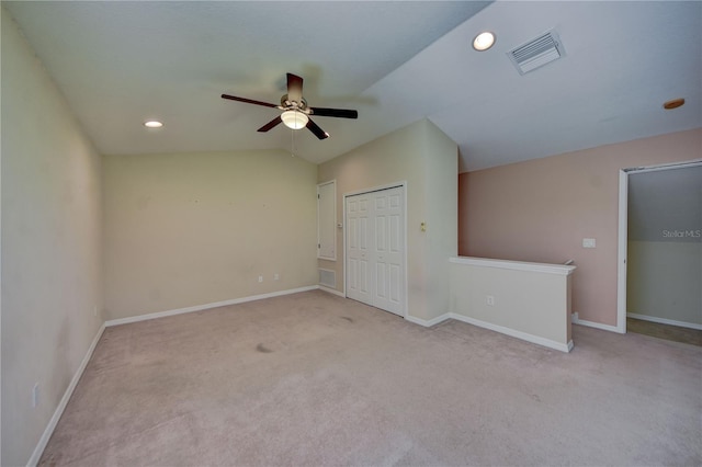 unfurnished room featuring vaulted ceiling, light carpet, and ceiling fan