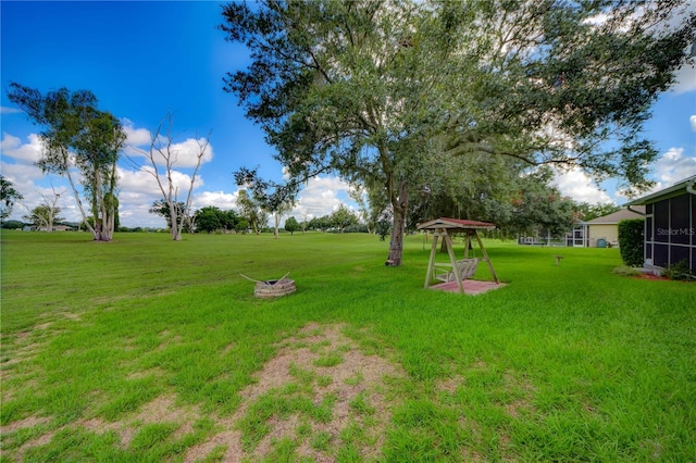 view of yard featuring an outdoor fire pit