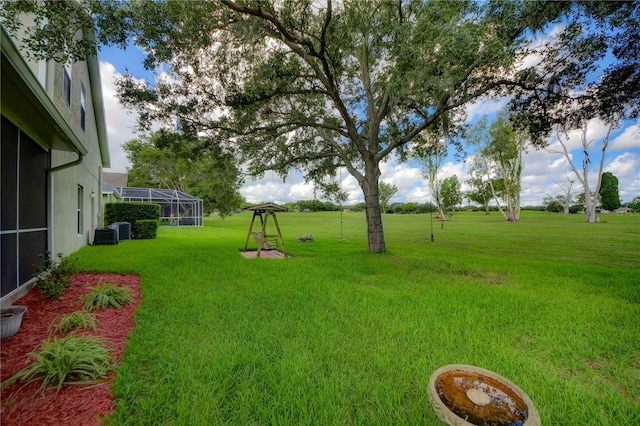 view of yard with a lanai and cooling unit