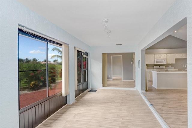 hall with light wood-style flooring