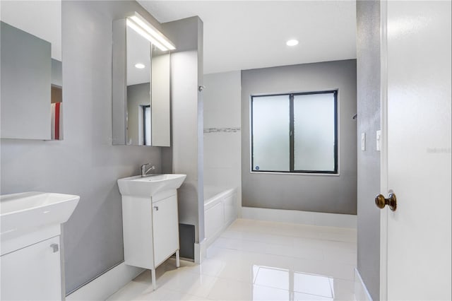 full bathroom featuring baseboards, two vanities,  shower combination, tile patterned flooring, and a sink