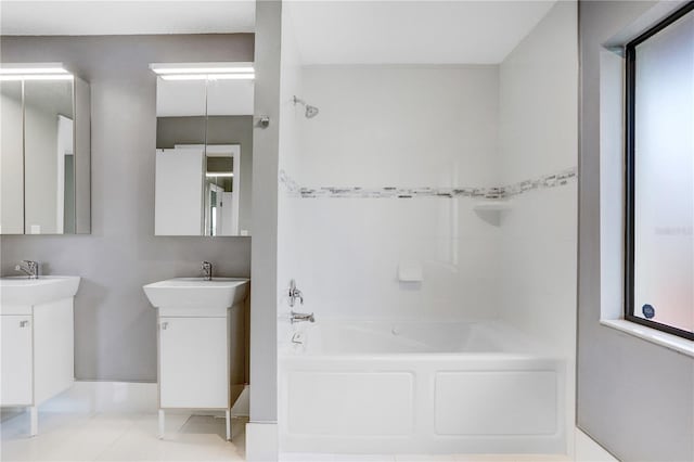 bathroom with tile patterned flooring, dual vanity, and shower / tub combination