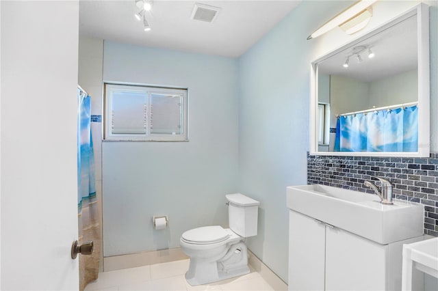 bathroom with tasteful backsplash, visible vents, toilet, vanity, and tile patterned floors