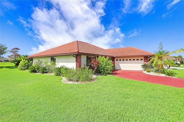 view of front of property featuring an attached garage, stucco siding, a tile roof, and a front yard