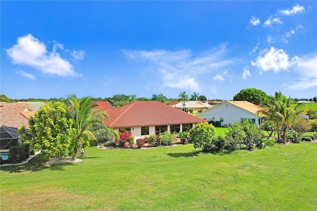 view of front of property featuring a front lawn and a tile roof