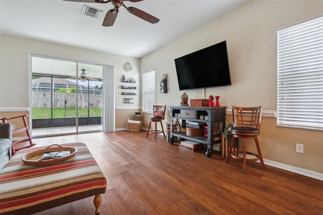 living room featuring ceiling fan and hardwood / wood-style floors