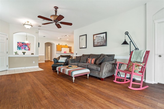 living room with hardwood / wood-style floors and ceiling fan