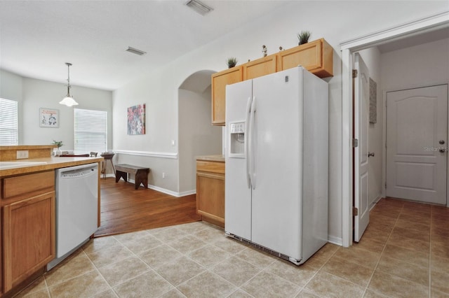 kitchen with white appliances and pendant lighting