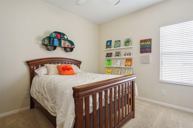 bedroom with ceiling fan and light carpet