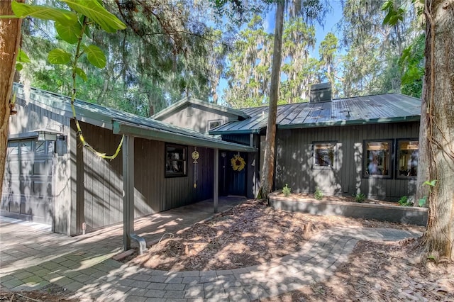 back of property featuring a garage