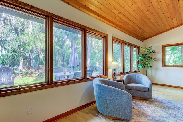 sitting room with lofted ceiling, wood ceiling, and light wood-type flooring