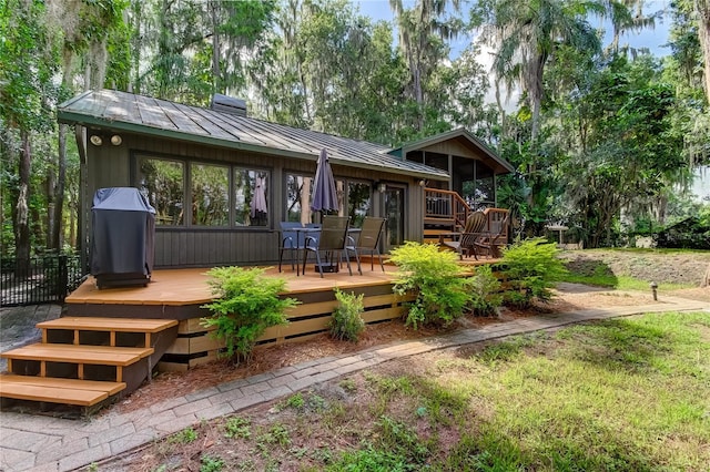 rear view of house featuring a deck