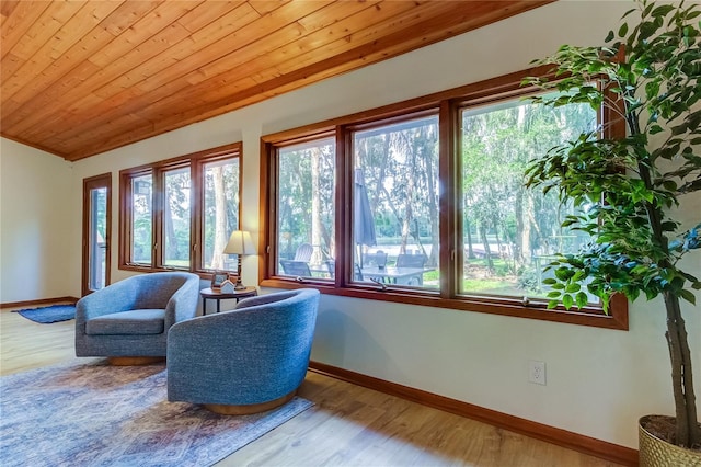 living area featuring wood-type flooring, plenty of natural light, and wooden ceiling