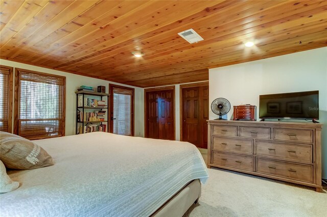 bedroom with light carpet and wooden ceiling