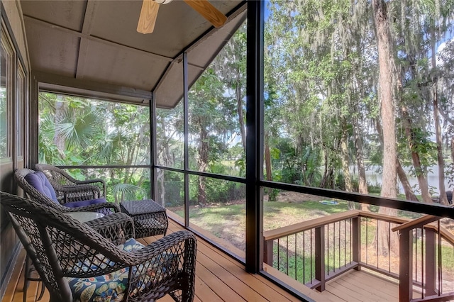 sunroom with a healthy amount of sunlight and ceiling fan