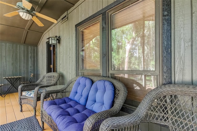 sunroom / solarium featuring lofted ceiling and ceiling fan