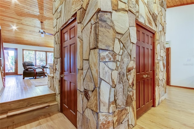 hall with vaulted ceiling, wooden ceiling, and light hardwood / wood-style floors