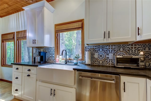 kitchen featuring white cabinetry, dishwasher, and sink