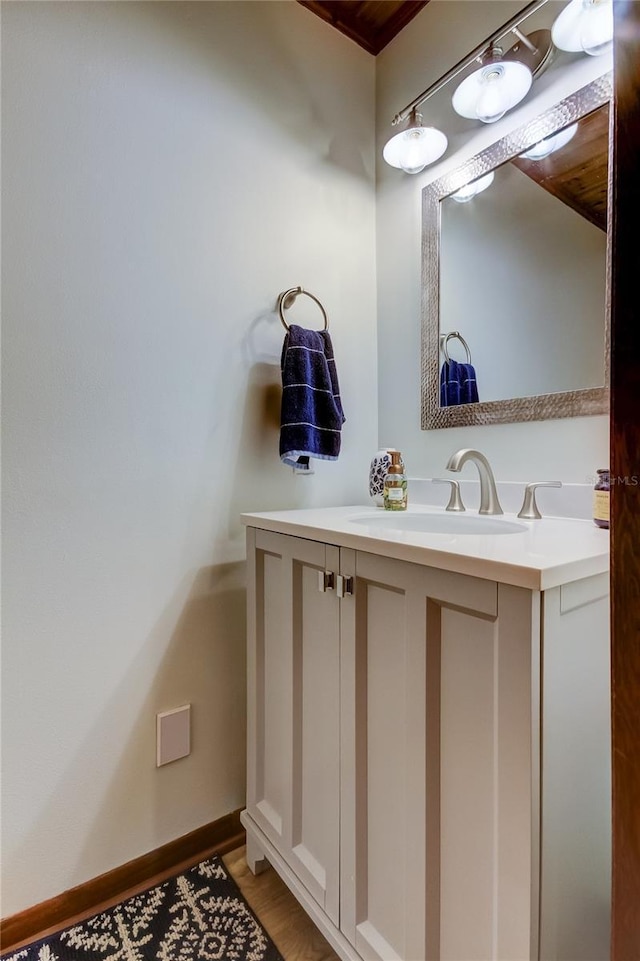 bathroom with hardwood / wood-style flooring and vanity