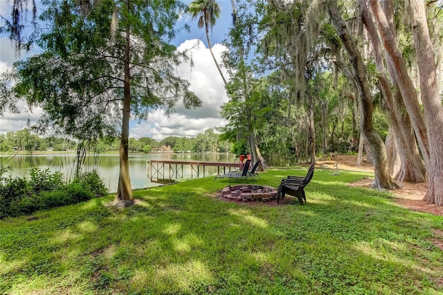 view of yard with a water view and an outdoor fire pit