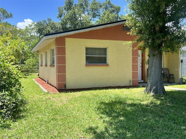 view of side of property with a lawn