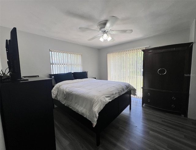 bedroom with ceiling fan and dark hardwood / wood-style floors