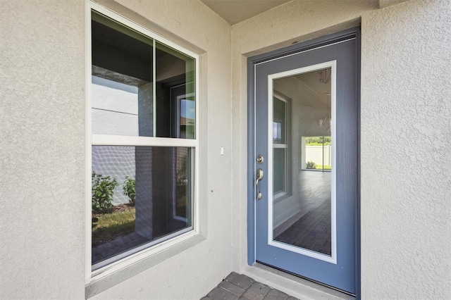 entrance to property with stucco siding