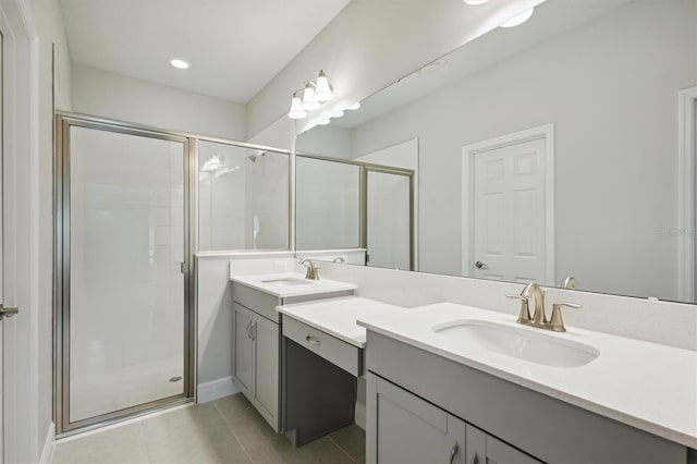 bathroom with double sink vanity, an enclosed shower, and tile patterned flooring