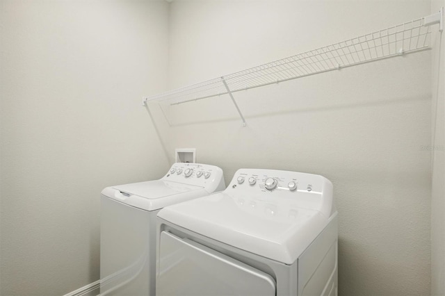 clothes washing area with washing machine and dryer