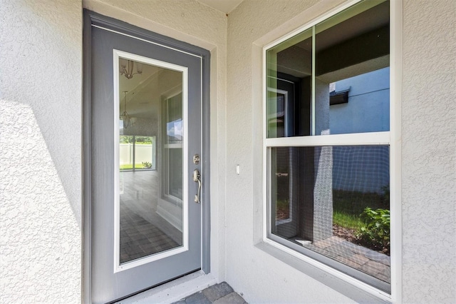 property entrance featuring stucco siding