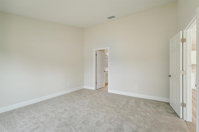 unfurnished bedroom with light carpet