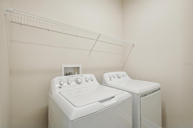 washroom featuring laundry area and washing machine and dryer